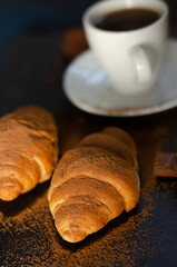 cup of coffee with chocolate croissants on the table