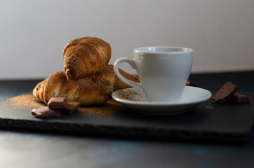 cup of coffee with chocolate croissants on the table