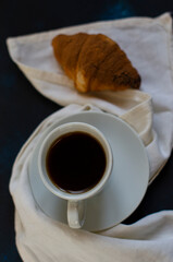 cup of coffee with chocolate croissants on the table