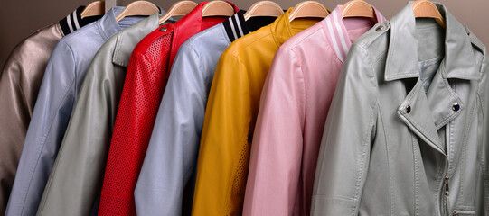 New collection of different color spring leather jackets for women. Colorful background of modern outerwear.