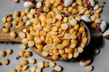 rice, buckwheat, peas in wooden spoons are on the table