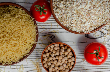 cereals in clay plates oatmeal, chickpeas, pasta