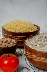 cereals in clay plates oatmeal, chickpeas, pasta