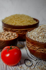 cereals in clay plates oatmeal, chickpeas, pasta