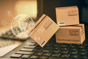 Shopping online, e-commerce concept: Cardboard boxes with icon customer network connection on keyboard. depicts of transportation that can be done easily using an online internet.