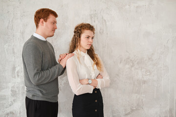 Obraz na płótnie Canvas Unhappy young couple arguing, offended affronted woman ignoring man staying her back husband wants to apologize to frustrated wife, family conflict at home, bad marriage relationships concept. Redhead