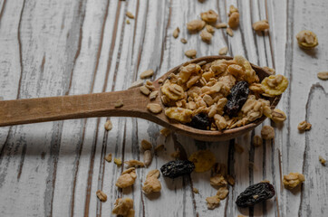 wooden spoon with granola on the table