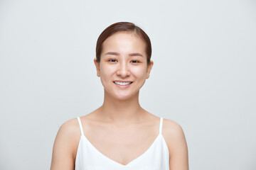 Smiling of young Asian woman with no make up on white background