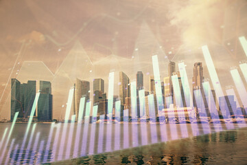 Obraz premium Forex chart on cityscape with tall buildings background multi exposure. Financial research concept.