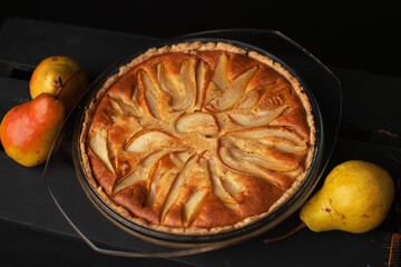 Tasty homemade pear pie on wooden background
