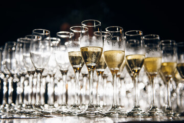 Many empty champagne glasses on table at party