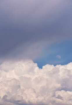 Blue sky with clouds and moon on the background
