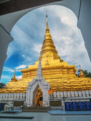 view of golden pagoda with cloudy sky background, Wat Phra That Chae Haeng, Nan Province, northern of Thailand.
