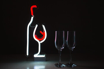 Neon sign of a wine bottle and a glass. Trendy stylish. Glowing life. Modern style. Neon sign.