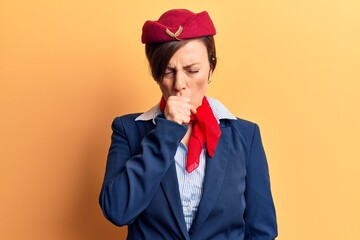 Young beautiful woman wearing stewardess uniform feeling unwell and coughing as symptom for cold or bronchitis. health care concept.