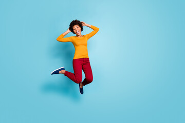 Full length body size view of nice attractive girlish overjoyed glad excited cheerful cheery wavy-haired girl jumping having fun leisure isolated on bright vivid shine vibrant blue color background
