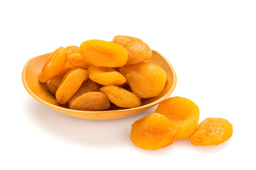 Preserved fruit. Dried sulfurized apricots in wooden bowl isolated on white background.