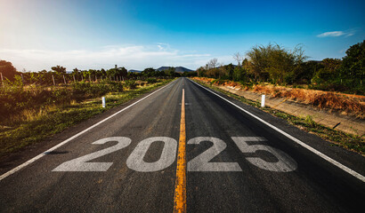 2025 written on highway road in the middle of empty asphalt road at golden sunset and beautiful...
