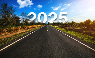 The word 2025 behind the tree of empty asphalt road at golden sunset and beautiful blue sky....