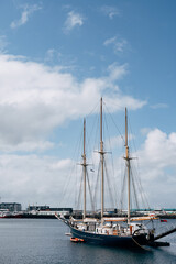 Sailing wooden ship with three masts moored in the port of Reykjavik, in the capital of Iceland.