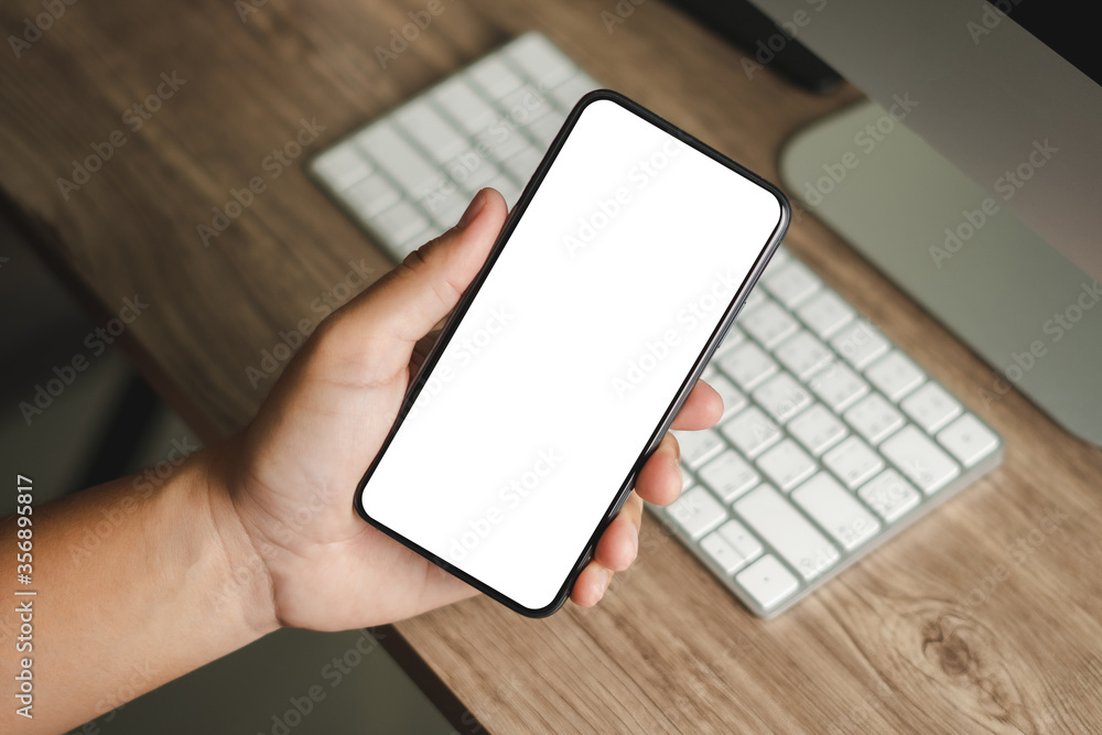 Poster top view mockup image hand using a smartphone man holding cell phone with blank screen