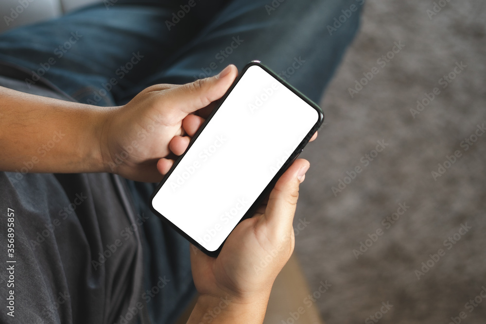 Poster top view mockup image hand using a smartphone man holding cell phone with blank screen