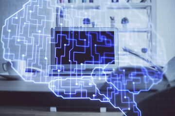 Double exposure of table with computer and brain hologram. Data innovation concept.