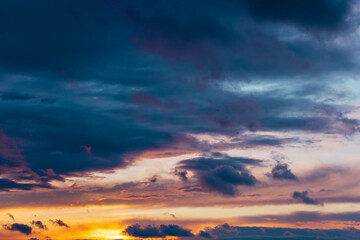 amazing sunset clouds with blue sky. Reflection of sunlight on the sea