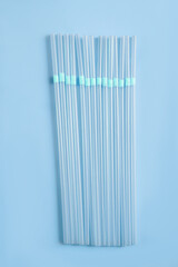 Blue plastic tubes for drinks on a blue background