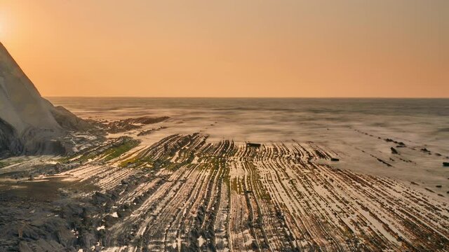 Amazing sunset at the flysch in the sea. Timelapse