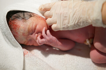 Close-up of newborn asian chinese baby right after delivery