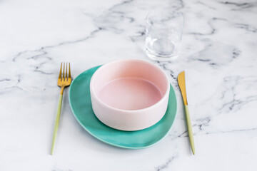 Stylish elegant table setting with ceramic plates on white marble background