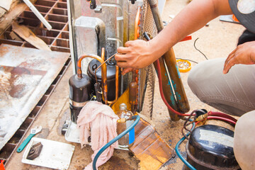 technician repair air conditioner by vacuum at maintenance shop
