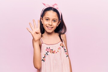 Beautiful child girl wearing casual clothes showing and pointing up with fingers number four while smiling confident and happy.