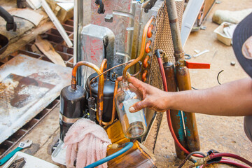 technician repair air conditioner by vacuum at maintenance shop