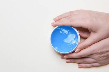 Skin care concept, anti-aging moisturizing eye mask, hydrogel patches in woman hands, with copy space