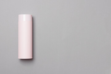 pink thermos cup on grey background with copy space