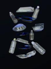 Falling clear water bottles on black background recyclables