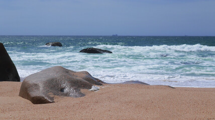A natural sculpture honed by the ocean itself. Seascape.
A stone, like a hand, whose fingers penetrated the sand.