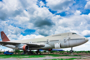 Fototapeta na wymiar Nakhon Pathom, Thailand - June, 09, 2020 : The old commercial aircraft was discharged with a stormy sky at Nakhon Pathom, Thailand