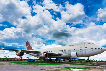 Nakhon Pathom, Thailand - June, 09, 2020 : The old commercial aircraft was discharged with a stormy sky at Nakhon Pathom, Thailand