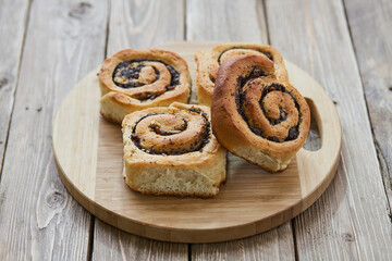 Tasty buns with raisins on a brown rustic wooden table. fresh bakery. breakfast. bread. top view