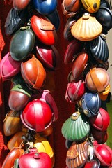 Colourful leather purses for sale outside a shop in the village centre, Frigiliana, Andalusia,...