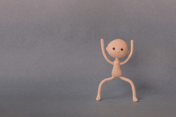 A toy man on a gray background with copy space. Cute amigurumi. Presentation PowerPoint or Keynote....