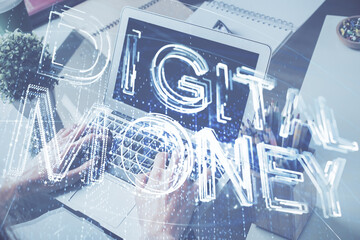 Crypto currency theme hologram with businessman working on computer on background. Concept of blockchain. Double exposure.