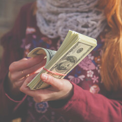 Portrait of young beautiful woman with US Dollar bills. Earnings, profits, accounting concept.