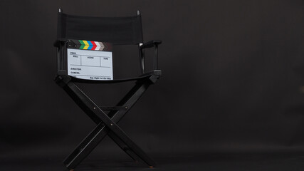 Director chair and Clapper board or movie slate and use in video production and cinema industry.It is put on black background.