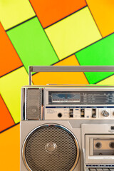 Silver 80s radio cassette on a colorful background. Play music concept.