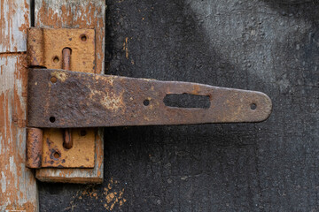 broken lock, bolt on the door with rust on the old door