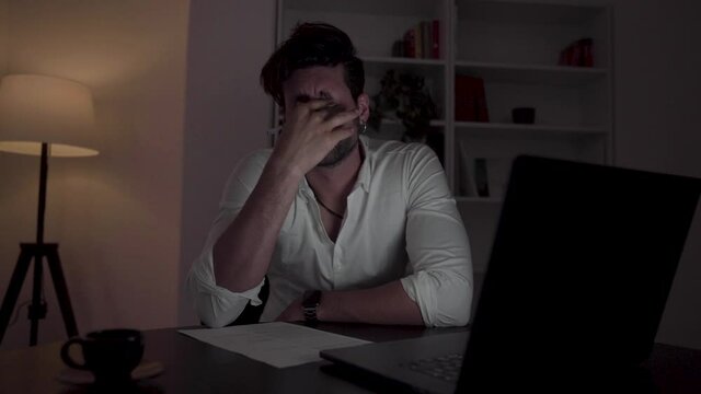 Young handsome businessman isolated working later. 
Working hard 